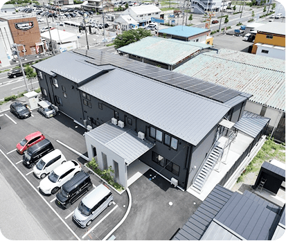 施設外観と駐車場（屋根に太陽光パネル）